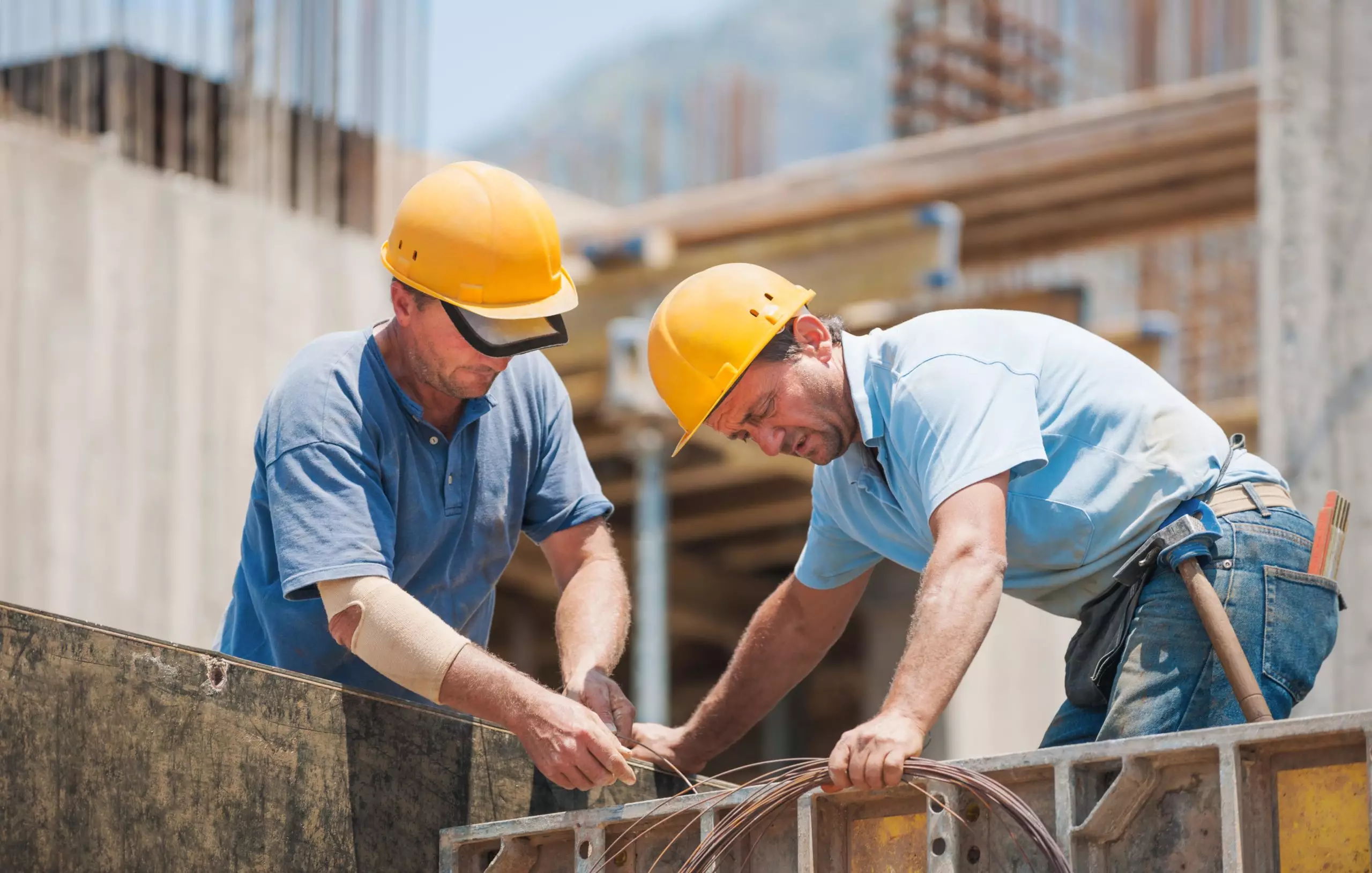 Construction workers working on cement